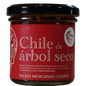 Frasco de salsa macha con chile de árbol seco. Etiqueta roja con calavera mexicana ilustrada.