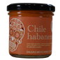 Frasco de salsa cremosa de chile habanero. Etiqueta naranja con ilustración de calavera mexicana tradicional.